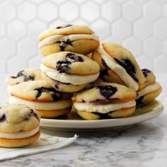 a pile of blueberry sandwich cookies on a plate