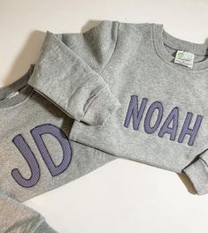 "This will be your \"go-to\" sweatshirt for your little one!  These sweatshirts scream COMOFORT! They are super soft and warm inside.  These sweatshirts are grey and feature an appliqué name with light navy gingham fabric.  PLEASE NOTE - fabric can be changed to a different color gingham or solid color! You must request this in the personalization box. Please select sweatshirt size. IN PERSONALIZATION BOX - Please type name you would like embroidered.   Please message me with any questions. I am Gray Long Sleeve Sweatshirt With Letter Embroidery, Winter Long Sleeve Sweatshirt With Name Print, Winter Crew Neck Sweatshirt With Name Print, Embroidered Name Sweatshirt, Spring Sweatshirt, Name Sweatshirt, Applique Sweatshirt, Navy Gingham, Embroidered Name