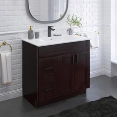 a bathroom with a sink, mirror and towel rack on the wall next to it