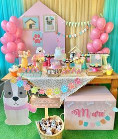 a table topped with lots of desserts and balloons