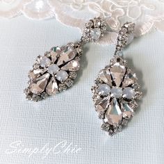 Hollywood Glam crystal earrings, made with top Swarovski rhinestones hand sett on silver filigree drop . finished with hypo allergenic surgical steal ear wire. Original design , hand crafted by me in my studio. Light weigh and very comfortable to wear . Other related accessories are coming soon ( necklace) Suggested Bracelet: https://www.etsy.com/listing/721178495/white-opal-wedding-cuff-bracelet-crystal?ref=shop_home_active_7 Please contact me if you have any questions. Dazzling Silver Crystal Embellished Earrings, Silver Sparkling Crystal Earrings, White Sparkling Crystal Bridal Earrings, Sparkling White Crystal Bridal Earrings, Crystal Embellished Dangle Earrings, Silver Sparkly Crystal Earrings, Sparkling Silver Crystal Bridal Earrings, White Crystal Bridal Earrings With Sparkling Stones, Silver Crystal Earrings With Bling