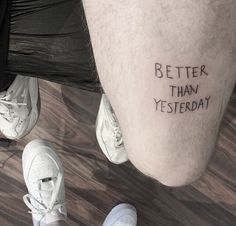 a person with a tattoo saying better than yesterday