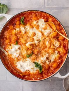 a pot filled with pasta and cheese on top of a table