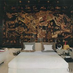 a bedroom with a large tapestry on the wall