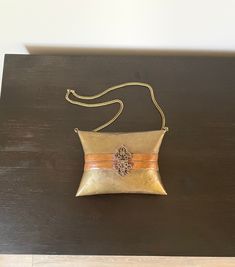 Bag Measures: 7-1/4"W x 5-1/4"H x 3-1/2"D Strap Measures: 13-1/4"L from top of bag to top of strap. This is a stunning vintage 1970s art deco metal pillow purse with a metal chain strap. The outer shell is made entirely of brass with a copper stripe detail in the center. The inside is lined with a deep crushed blue velvet. The back does have the original 'Made In India' sticker on it. Item Condition: This piece is in amazing vintage condition with no noticeable dents or large scratches. It currently has some patina on it, but it could also be shined up easily. I like to let the buyer choose how they'd like to display it when it comes to pieces like this. **Buyer is responsible for reviewing all measurements, all photos, & entire item description before purchasing. Pillow Purse, 1970s Art Deco, 1970s Art, Art Deco Metal, Blue Velvet, Vintage 1970s, Clutch Handbag, Metal Chain, Chain Strap