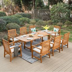 an outdoor dining table and chairs on a deck