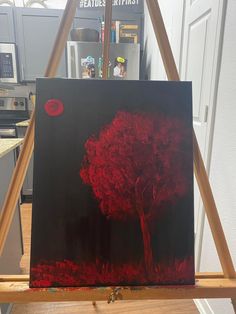 an easel with a painting on it in the process of being painted by someone