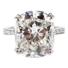 a cushion cut diamond ring with pave set shoulders