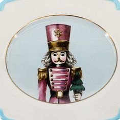 a plate with an image of a nutcracker on it's front and side