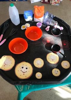 a black tray topped with cupcakes and baking utensils on top of a table