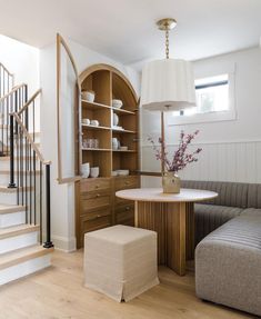 a living room filled with furniture and a spiral staircase