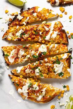 grilled sweet potatoes with corn and feta cheese on a white plate next to lime wedges