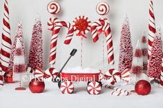 some candy canes and christmas decorations on a white table with red and white balls