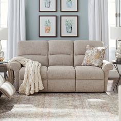 a living room scene with focus on the couch and reclining chair in the foreground