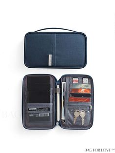 an open suitcase with keys and other items in it on a white surface, top view