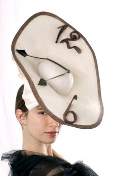 "A Statement Ascot Fascinator hat, Kentucky derby fascinator, Melbourne cup hat inspired by Salvador Dali's \"Nobility of time\". This extraordinary \"Watch\" hat is made from ivory paper, brown sinamey numbers and black feather hands/arrows. there is also a big bow-knot and for better stability the hat is secured with milliner elastic. Unique hat! This amazing hat is made to order - please let us 1-2 weeks to recreate it Please send me your head size when ordering so we can adjust it for you. A Navy Fascinator, Racing Fashion, Statement Hat, Kentucky Derby Fascinator, Royal Ascot Hats, Derby Fascinator, Ascot Hats, Hat Fascinator, Crazy Hats