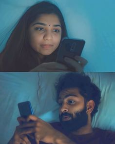 a man and woman laying in bed looking at their cell phones while they look at each other