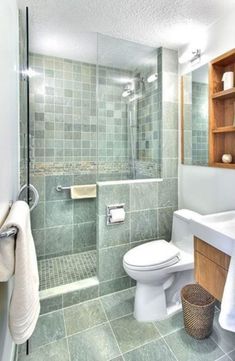 a bathroom with a toilet, sink and shower