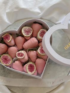 a heart shaped box filled with pink candy