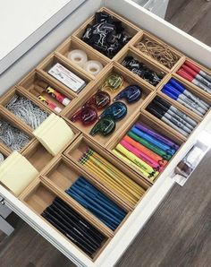 an organized drawer with lots of different colored pencils