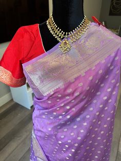 This is a light weight, handwoven semi georgette Banaras saree with gorgeous silver zari border and small bhuttis. This soothing lavender shade saree comes with a contrast red blouse. The saree can be easily draped and is very classy. Blouse is fully stitched and is open with hooks and dori at the back. Blouse is size adjustable from 36-44 inches (with margins inside) Falls/pico are already done and saree is ready to wear. Size 36-44 adjustable stitched blouse : Banaras semi georgette saree silver zari  | gajji silk sarees online shopping us | silver zari saree Traditional Silver Pre-draped Saree With Pallu, Silver Pre-draped Saree With Zari Work For Festive Occasion, Silver Bollywood Pre-draped Saree For Festive Occasions, Festive Silver Bollywood Pre-draped Saree, Festive Chanderi Blouse Piece With Tilla Details, Diwali Chanderi Blouse Piece With Tilla, Silver Pre-draped Saree With Unstitched Blouse For Festive Occasions, Festive Silver Pre-draped Saree, Silver Bollywood Style Pre-draped Saree For Diwali