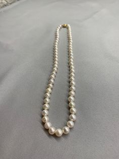 White Freshwater Pearl Necklace. This hand knotted necklace features 62 White Freshwater Pearls AAA High Luster Round to Near Round rose overtones 7-7.5mm. I hand knotted this strand with white silk thread and finished it with a 14K yellow gold corrugated bead clasp 6mm. The necklace measures 18 inches in length. The pearls are genuine and natural in color. This is a classic strand of pearls that can be worn for any occasion. These freshwater pearls are all nacre and should hold up well for many White Hand Knotted Jewelry With Round Beads, Formal White Hand-strung Jewelry, Elegant Hand Knotted White Jewelry, Hand Knotted White Round Bead Jewelry, Hand Knotted Necklace, Knotted Necklace, Corpus Christi Tx, Gold Pearl Necklace, Pearl Choker Necklace