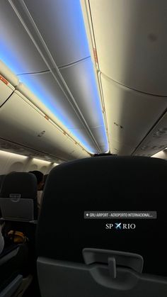 the interior of an airplane with its lights on