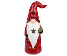 a red and white santa claus figurine with stars on his hat, holding a green ball