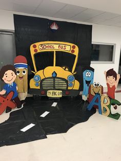 the school bus is made out of cardboard and has children's faces on it