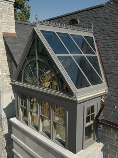 a house with a large glass window on the roof