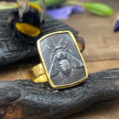 "In Ancient Greece, The Queen Bee was a sacred symbol of the Goddess Artemis As a symbol of the Mother Goddess, bees represent feminine support and fertility. The bee is a emblem of Ephesus, a Greek city on the west coast of Turkey. This city was an important center of worship for the Greek goddess Artemis, and the images on Ephesian coinage typically promote this association. The bee was originally the symbol of an early Anatolian goddess who the Greeks later identified with their goddess, Artemis so close was the connection that the priestesses of the goddess were called \"honey bees.\" The two Greek letters, Ε ('epsilon') and Φ ('phi'), are an abbreviation for Ephesus. The city was famous in its day for the nearby Temple of Artemis completed around 550 BC, which has been designated one Symbolic Hand Forged Engraved Ring As Gift, Symbolic Hand-forged Engraved Ring As A Gift, Symbolic Hand Forged Engraved Ring For Gift, Etched Brass Rings As Gifts, Nature-inspired Etched Rings Ideal For Gifts, Etched Brass Rings For Gifts, Nature-inspired Brass Rings For Gifts, Bumble Bee Ring, Goddess Artemis