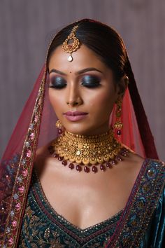 a woman wearing a bridal outfit and jewelry