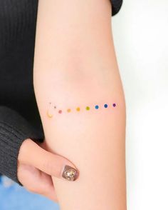 a woman's arm with dots on it