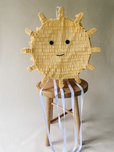 a piece of wood that looks like a sun sitting on top of a stool