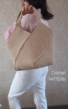 a woman carrying a crochet purse on her back with white pants and pink shirt