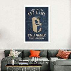 a living room with a couch, coffee table and poster on the wall that says i don't need to get a life i'm a gamer