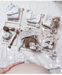 baby items are laid out on top of a bed with the names of their babies