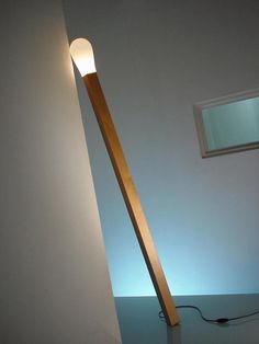 a light that is on the side of a wall next to a lamp in a room