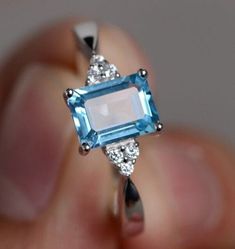 100% Natural Gemstone, Swiss Blue Topaz Jewellery Ring, 925 Sterling Silver Ring, Birthstone Ring, Authentic Ring, Anniversary Ring, Topaz Zircon Ring Stone Name  :-  Swiss Blue Topaz Secondary Stone :-  Zircon Stone Shape  :- Rectangle Cut Stone Size     :- 8x6 MM Material    :- 925 Sterling silver Accept Custom Orders Service. ❁❁ 𝐉𝐞𝐰𝐞𝐥𝐫𝐲 𝐂𝐞𝐫𝐭𝐢𝐟𝐢𝐜𝐚𝐭𝐞 ❁❁ ↣ KHJewels branded authenticate Jewellery Certificate comes with the authenticity of Metal, Moissanite, and Gemstone combination. ↣ The certificate comes with Limited Lifetime Warranty details. ↣ Listed Jewellery comes with a branded Jewellery Certificate on request. ↣ If you want to get the certificate with your ordered jewellery then please contact me within 72 hours of your order placed. ↣ The certificate is Chargeable Square Diamond Rings, Rainbow Topaz, Blue Topaz Jewelry, Princess Cut Rings, Gem Ring, Square Diamond, Zircon Ring, Swiss Blue Topaz, Blue Topaz Ring