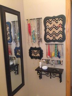 there is a mirror and some jewelry on the wall