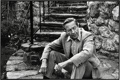 black and white photograph of a man sitting on steps