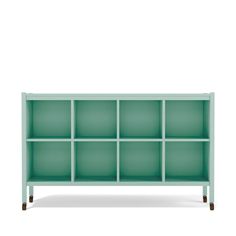 a green shelf with many compartments on it