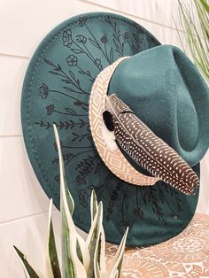 Wildflower Floral Burned Hat, Floral Engraved Cowboy Hat, Sunflower Hat, Sunflower Burned Fedora, Engraved Fedora, Engraved Felt Hat, Boho Hat Elevate your style with our beautifully engraved floral hats! If you want certain colors for the feather/flower detail, please leave a note at checkout. Bands and florals/feathers may shift or fall off during shipping. The hat has an adjustable band on the inside to fit many sizes. One size fits most adult heads. Green Brimmed Felt Hat For Festival, Bohemian Green Fedora Sun Hat, Green Bohemian Fedora Sun Hat, Green Bohemian Hat Bands For Spring, Adjustable Green Bohemian Felt Hat, Green Wide Brim Felt Hat For Festival, Bohemian Green Fedora Felt Hat, Green Bohemian Brimmed Straw Hat, Green Flat Brim Festival Hat