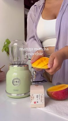 a woman is peeling mangoes in her kitchen with a juicer and blender