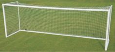 a white soccer goal on the grass