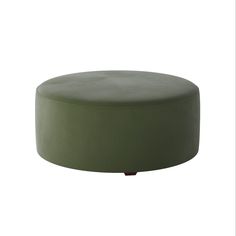 a green ottoman sitting on top of a white floor