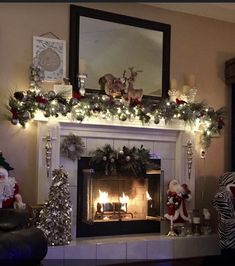 a fireplace decorated with christmas decorations and lights