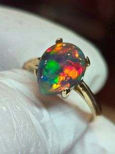 Natural  fire opal with a full flagstone pattern,very good fire, 14k solid gold, bright and colorful. Original and one of a kind stone, 9x14mm, 5.25cts .  Mounted on a very sturdy and heavy, solid 14k yellow gold ring size 7, But can be made in any size 4 through 9 including halfs and quarters , an  extra a wait of 1  to 2 weeks. Very nice choice for active people. Prongs will be closed when the finger size is determined. Just leave a note if you need halves or quarter sizes Engagement Ring Black, Vintage Opal Engagement Ring, Black Fire Opal, Natural Opal Ring, Jewelry Opal, Ring Opal, Fire Opal Ring, Opal Engagement, Black Fire