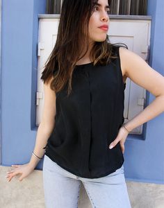 Original vintage top in a black pure silk. Sleeveless. Button detail to neckline. UK 10 / Eur 38 Measurements - 34"(87cm) bust, 23"(59cm) shirt length. Material - Pure silk. Condition - Excellent. Handpicked, repaired and ready to wear. This is an original vintage item, not new and minor signs of wear & age are expected, we will highlight any major flaws. Model is a UK size 8 and is 5'6" tall. Black Silk Camisole Top, Black Silk Sleeveless Tank Top, Sleeveless Viscose Tops For Night Out, Black Sleeveless Viscose Top, Chic Black Rayon Blouse, Sleeveless Rayon Top For Work, Black Silk Camisole For Spring, Black Silk Summer Blouse, Black Silk Blouse For Summer