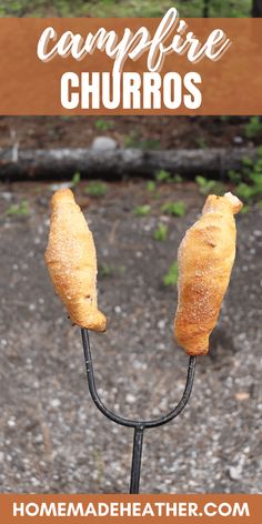 two croissants sitting on top of a black stick with the words campfire churros